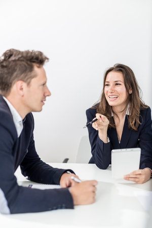 Businessman and businesswoman discussing on a meeting.の写真素材