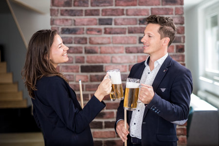 Couple of billiard players cheering with beer.の写真素材
