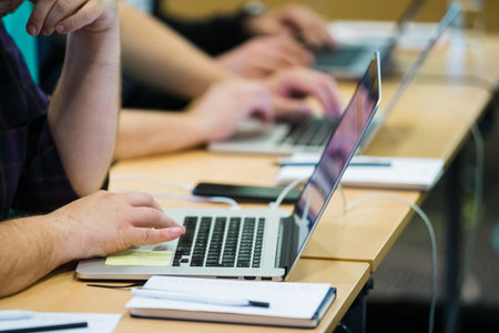 Businessman using laptop touch pad on meeting or seminar.