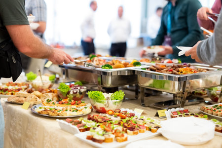 People enjoying buffet meal.の写真素材