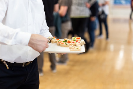 Waiter holding tray of appetizers.の写真素材