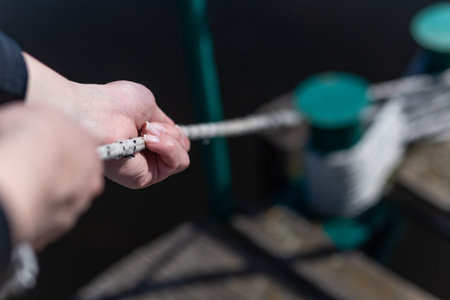 Close up of female hands holding boat ropeの写真素材