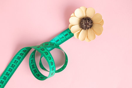 Flat lay of measuring tape in form of flower minimal creative concept.の写真素材