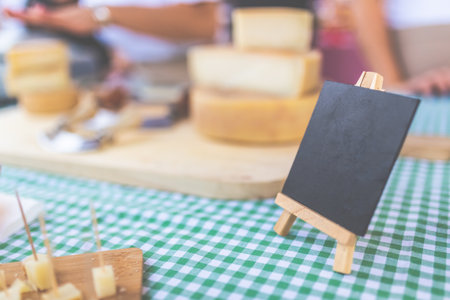 Agricultural fair traditional cheese stand with blank price or text board copy space.の写真素材