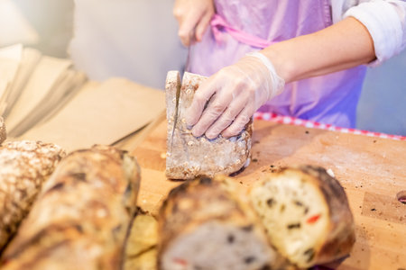 Woman hands slicing home made bread.の写真素材