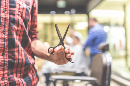 Close up of fashionable barber holding scissors.の写真素材