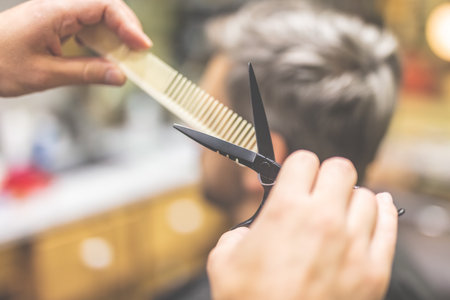 Man in barber chair, hairdresser styling his hair.の写真素材