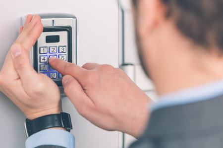 Human hand pressing the security code combination to unlock the doorの写真素材