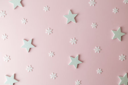 Pattern made of white stars and snowflakes on pastel pink background minimal creative christmas holiday and winter concept.の写真素材