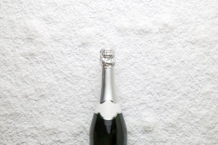 Top view of champagne bottle in snow. Celebration concept. Space for copy.の写真素材