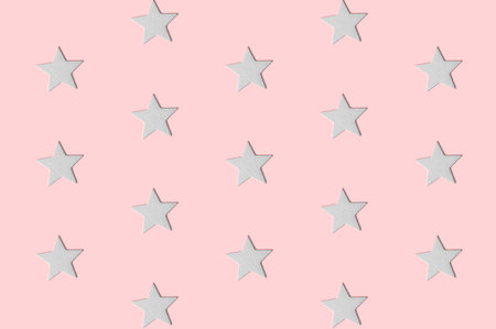 White decorative stars pattern on pastel pink background minimal creative concept.の写真素材