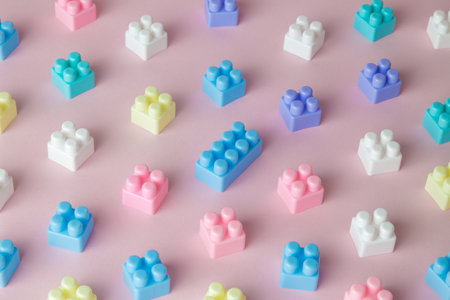 Plastic building blocks toy pattern on pastel pink background minimal creative concept.の写真素材