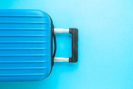 Suitcase on pastel blue background minimal creative travel concept. Space for copy.の写真素材