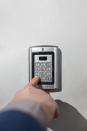 Close up of businessman hand entering security system code. Space for copy.の写真素材