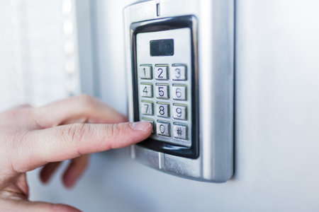 Man hand pressing the security code combination to unlock the doorの写真素材