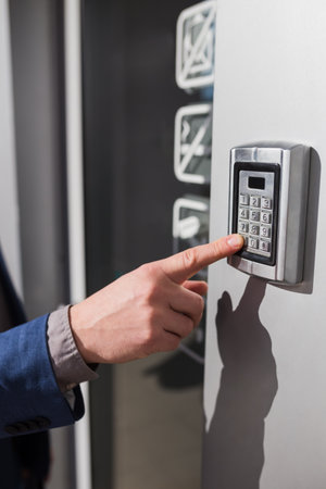Close up of businessman hand entering security system code.の写真素材