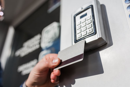 Door access control. Man hand holding key card to lock or unlock door.の写真素材