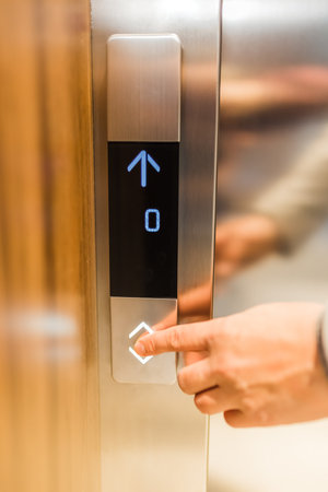 Man forefinger pressing up or down elevator button. Business success or failure concept.の写真素材