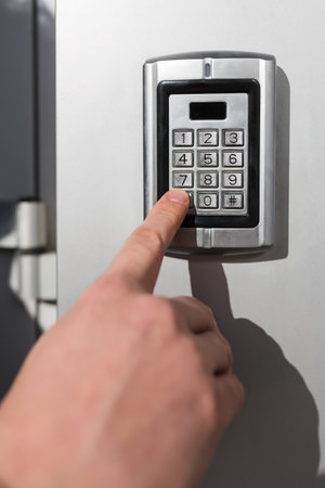 Close up of businessman hand entering security system code.の写真素材