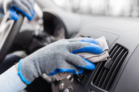 Auto service staff hand cleaning car interior with microfiber cloth. Car detailing and valeting conceptの写真素材