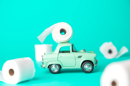 Small car with toilet paper corona virus pandemic panic minimal creative concept.の写真素材