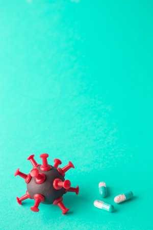 Pills and coronavirus cell minimal creative pandemic and cure concept. Space for copy.の写真素材