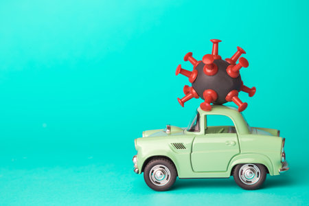 Small car with corona virus cell symbol pandemic panic minimal creative concept.の写真素材
