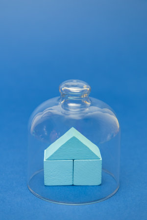 Stay at home minimal creative concept made of cubes toy in form of house under glass cover. Isolation and quarantine coronavirus abstract.の写真素材