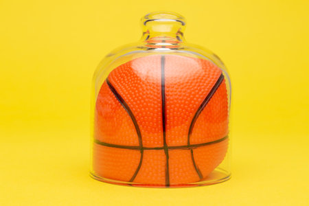 Basketball ball in quarantine. Sport and coronavirus minimal creative concept.の写真素材