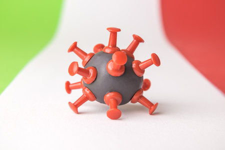 Close up of coronavirus bacterium cell model on italian flag minimal creative healthcare concept.の写真素材