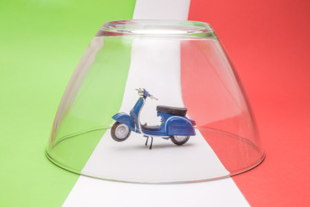 Close up of scooter in quarantine on italian flag minimal creative healthcare concept.の写真素材