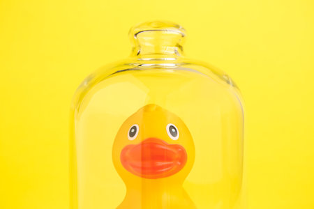Rubber duck in isolation from covid-19 under glass cover abstract.の写真素材