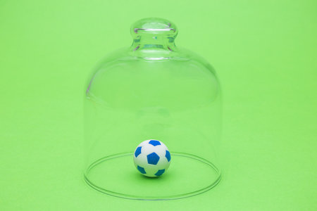 Soccer ball in quarantine. Sport and coronavirus minimal creative concept.の写真素材