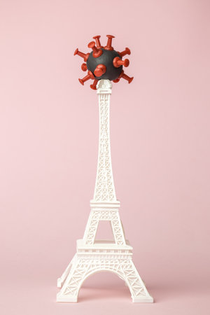 Coronavirus model on the top of Eiffel Tower minimal creative pandemic concept.の写真素材