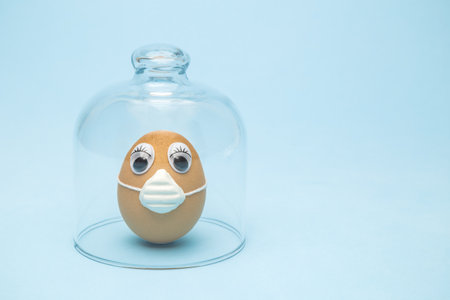 Egg with protective mask in quarantine minimal creative easter 2020 coronavirus pandemic concept.