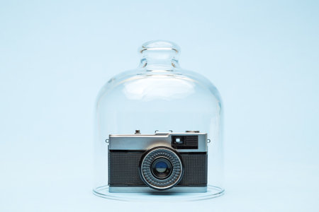 Retro film photo camera in quarantine minimal creative coronavirus travel or celebration event cancellation concept.の写真素材