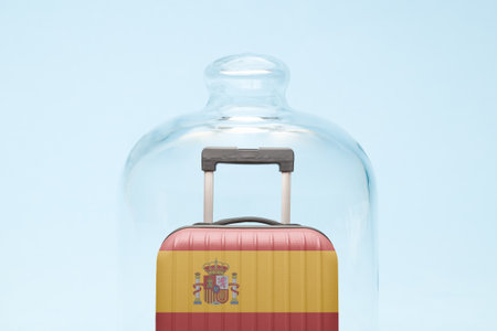 Suitcase with Spanish flag design in quarantine minimal creative coronavirus travel restriction concept.の写真素材
