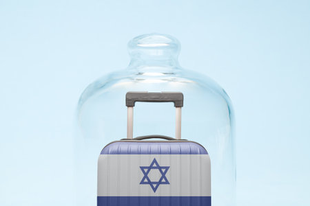 Suitcase with Israeli flag design in quarantine minimal creative coronavirus travel restriction concept.の写真素材