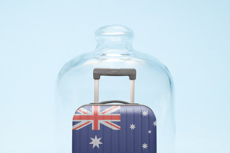 Suitcase with Australian flag design in quarantine minimal creative coronavirus travel restriction concept.の写真素材