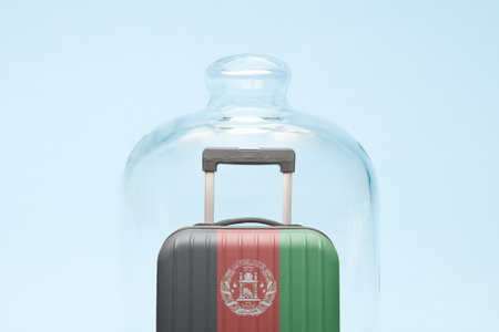 Suitcase with Afghan flag design in quarantine minimal creative coronavirus travel restriction concept.の写真素材
