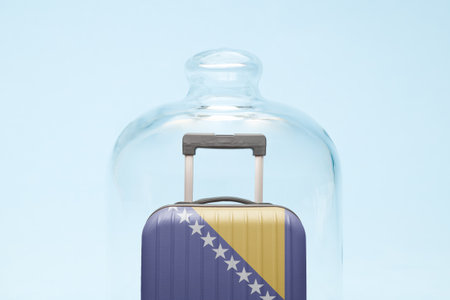 Suitcase with Bosnia and Herzegovina flag design in quarantine minimal creative coronavirus travel restriction concept.の写真素材