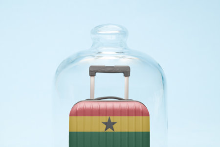 Suitcase with Ghana flag design in quarantine minimal creative coronavirus travel restriction concept.の写真素材