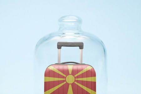 Suitcase with North Macedonian flag design in quarantine minimal creative coronavirus travel restriction concept.の写真素材