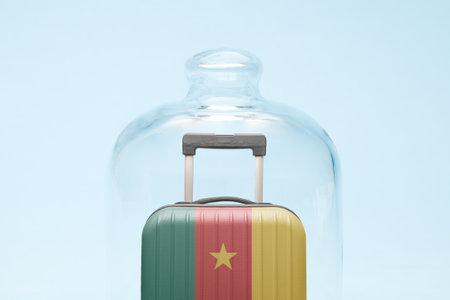 Suitcase with Cameroon flag design in quarantine minimal creative coronavirus travel restriction concept.の写真素材
