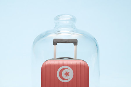 Suitcase with Tunisian flag design in quarantine minimal creative coronavirus travel restriction concept.の写真素材