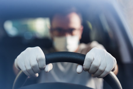 Portrait of driver with face mask and medical gloves, coronavirus pandemic concept.の写真素材