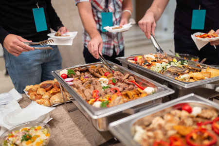 People choosing fresh prepared food from buffet table.の写真素材