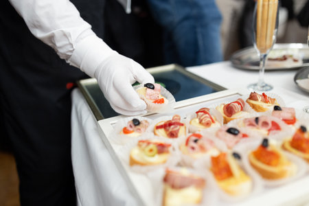 Waiters serving buffet canape food at the table on celebration event.の写真素材