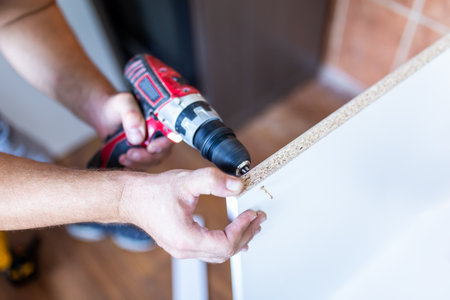 Male Using Self-Assembly Kit Making Cabinetの写真素材