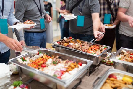 People scooping food. Buffet catering at restaurant or hotel concept.の写真素材
